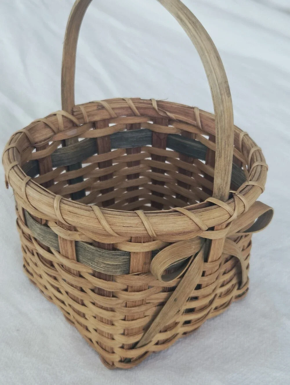 Vintage, Hand-Woven Basket Featuring A Unique Bow Detail And Green Accent